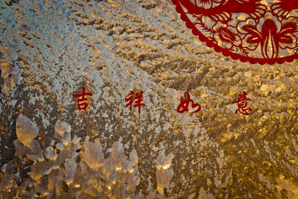 内蒙古的冬季室内外温差大，窗户上霜冻出冰凌花，带着春节的祝福，随手拍下以作纪念。